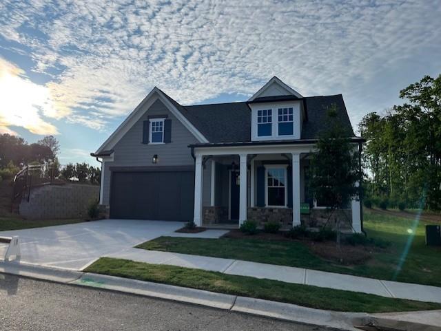 1209 Lakeside Overlook, Canton, GA 30114 - craftsman house with a garage, concrete driveway, a front lawn, and stone siding