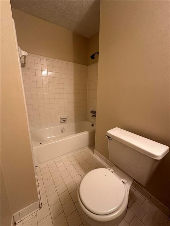 213 Peartree Ln, Riverdale, GA 30274 - bathroom with tile patterned flooring, toilet, shower / bath combination, a textured ceiling, and baseboards