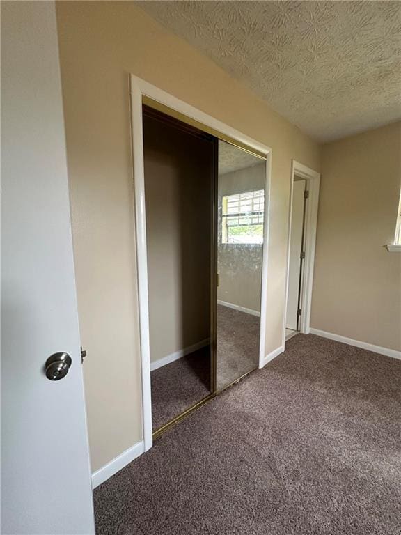 213 Peartree Ln, Riverdale, GA 30274 - unfurnished bedroom with carpet floors, a textured ceiling, a closet, and baseboards