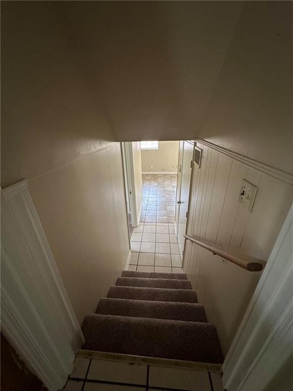 213 Peartree Ln, Riverdale, GA 30274 - staircase featuring tile patterned floors, a decorative wall, and a wainscoted wall