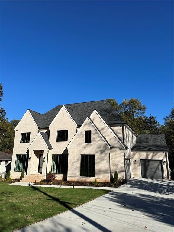 view of front of property with a front yard and a garage