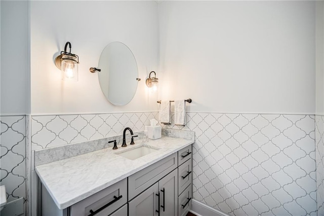 bathroom featuring vanity and tile walls