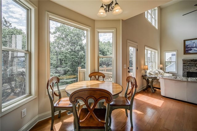 dining space with a wealth of natural light, light hardwood / wood-style floors, and a fireplace