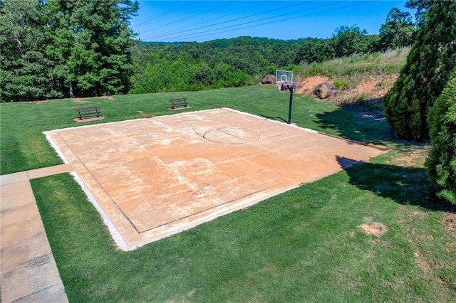 view of basketball court with a yard