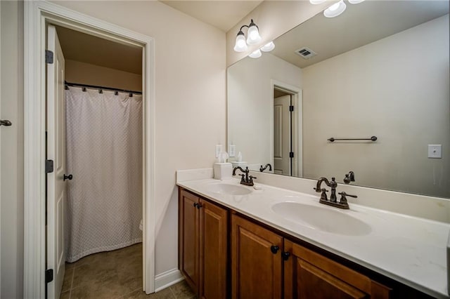 bathroom with walk in shower, tile patterned flooring, and vanity