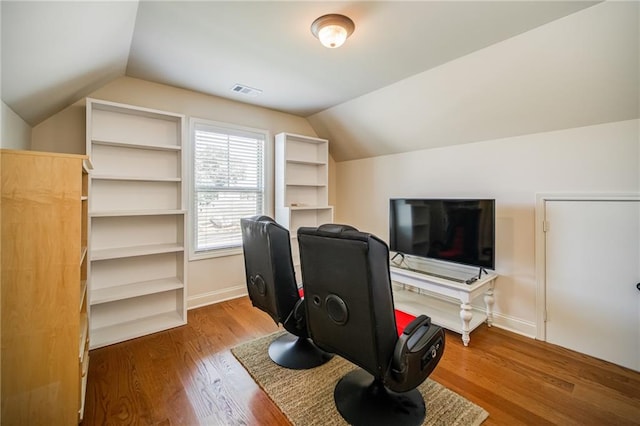 office with hardwood / wood-style floors and lofted ceiling