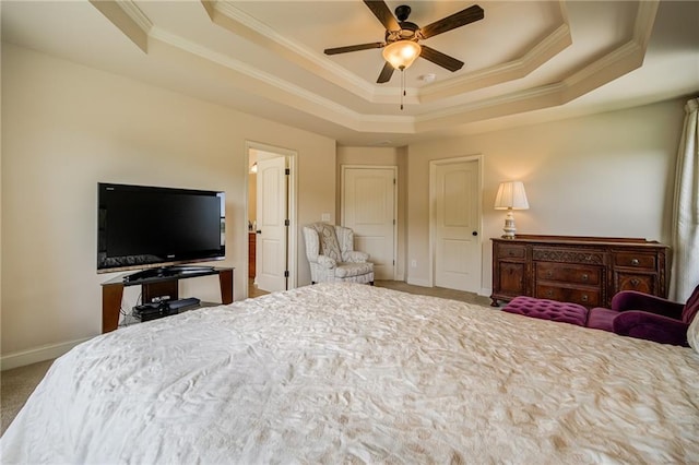 carpeted bedroom with crown molding, ceiling fan, and a raised ceiling