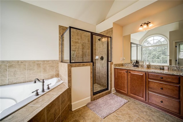 bathroom with vanity, tile patterned flooring, separate shower and tub, and vaulted ceiling