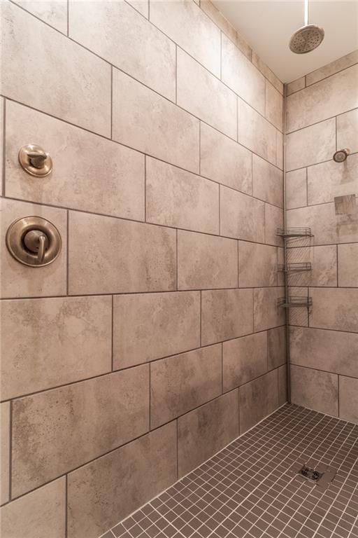 bathroom with a tile shower