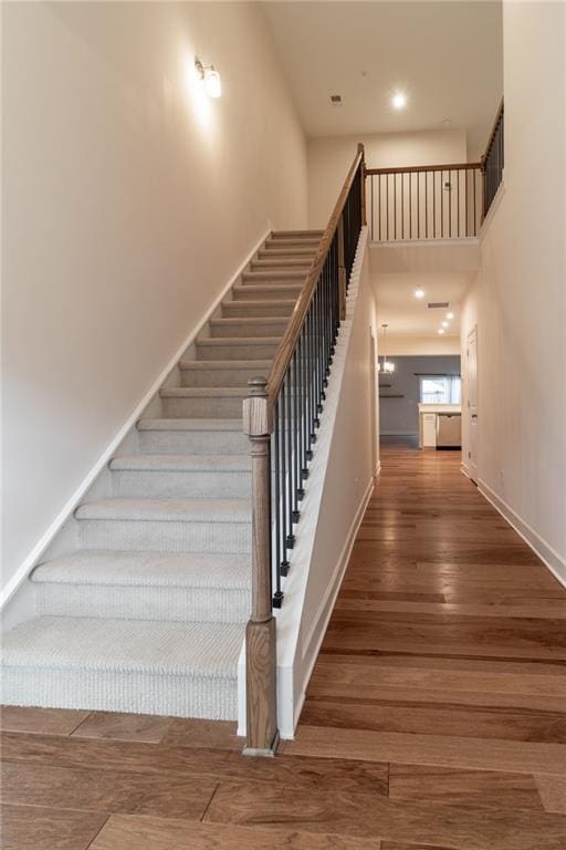 staircase with hardwood / wood-style flooring