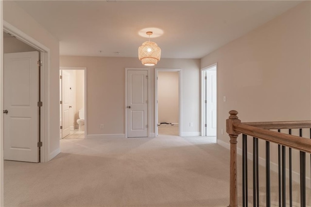 corridor with light colored carpet