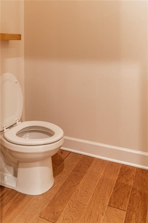 bathroom with wood-type flooring and toilet