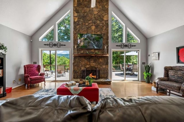 living room featuring plenty of natural light, high vaulted ceiling, and light hardwood / wood-style floors