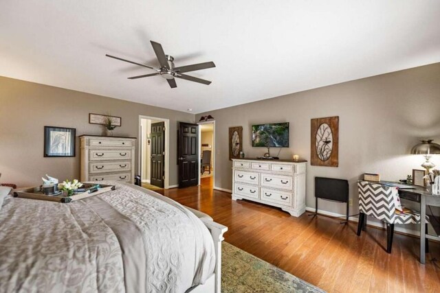 bedroom featuring ceiling fan and dark hardwood / wood-style floors