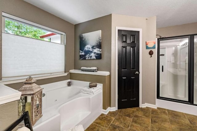 bathroom featuring tile patterned floors, separate shower and tub, and a textured ceiling