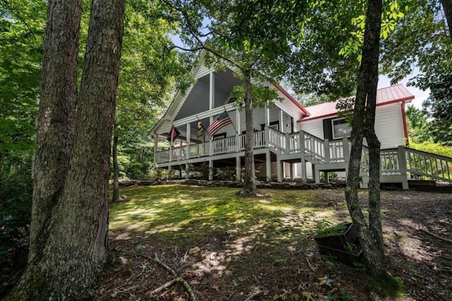 rear view of property with a wooden deck