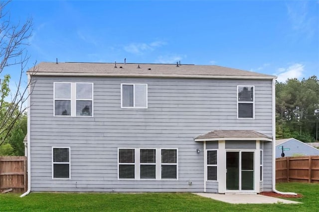 rear view of house with a yard