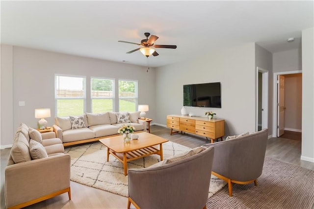 living room featuring hardwood / wood-style flooring and ceiling fan