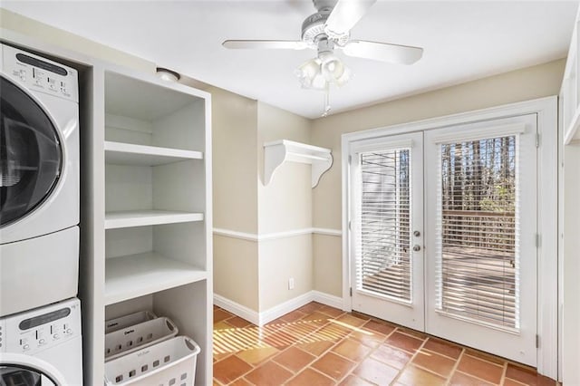 laundry area with laundry area, baseboards, ceiling fan, stacked washer / drying machine, and french doors