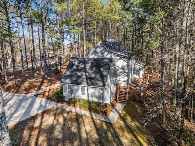 view of outbuilding featuring stairway and dirt driveway