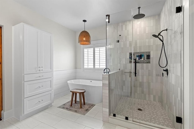 31 Copper Leaf Ct, Villa Rica, GA 30180 - full bath with a shower stall, a freestanding bath, tile patterned flooring, and wainscoting