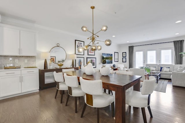 dining space with an inviting chandelier and dark hardwood / wood-style flooring