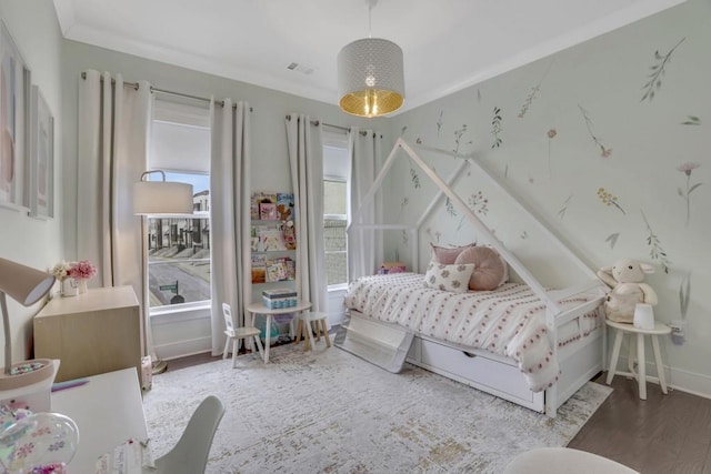 bedroom featuring hardwood / wood-style flooring and ornamental molding