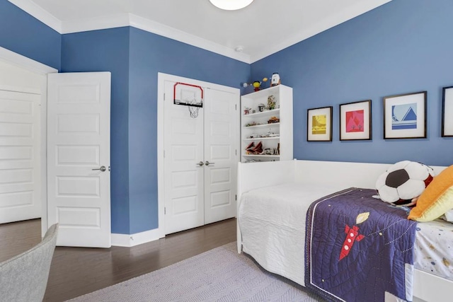 bedroom with crown molding and wood-type flooring