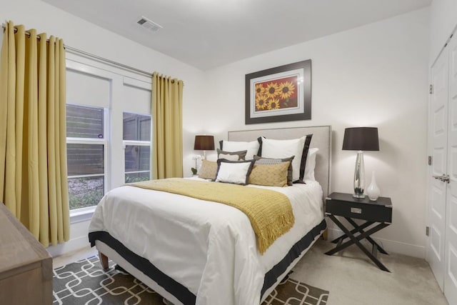 bedroom with light colored carpet