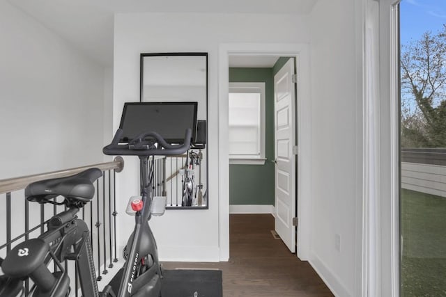 workout room with dark wood-type flooring and plenty of natural light