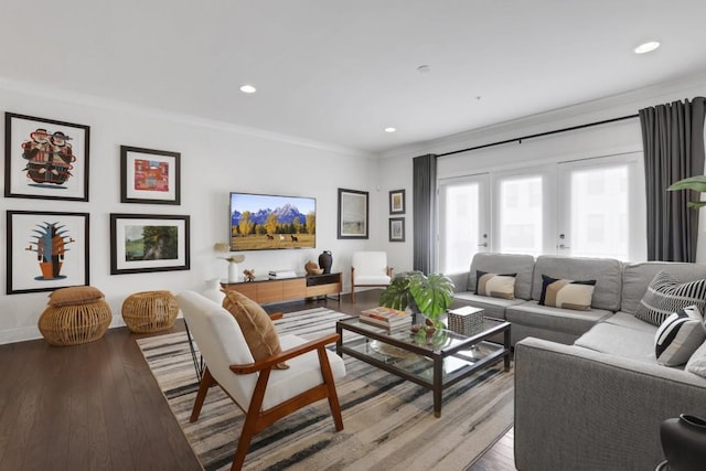 living room with crown molding, light hardwood / wood-style floors, and french doors