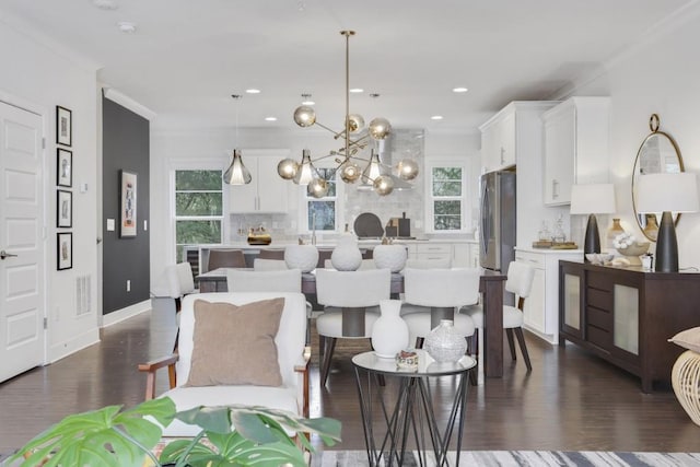 dining area with crown molding and a healthy amount of sunlight