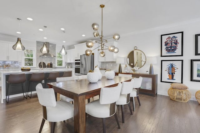 dining area featuring dark wood-type flooring and ornamental molding