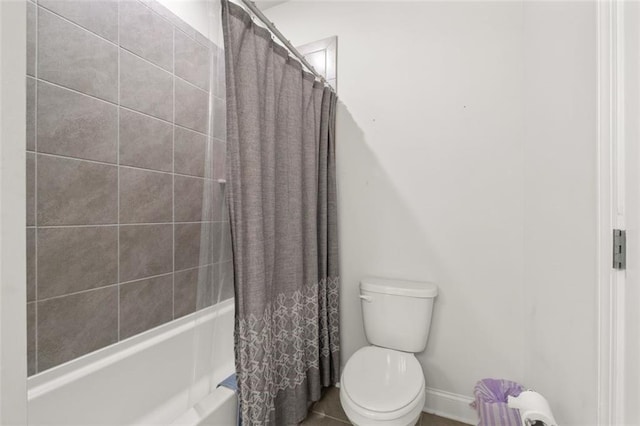 bathroom featuring shower / bathtub combination with curtain and toilet