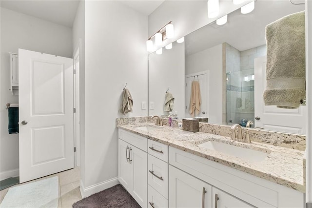 bathroom with vanity, a shower with shower door, and tile patterned floors