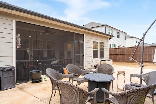 view of patio featuring a sunroom and ceiling fan