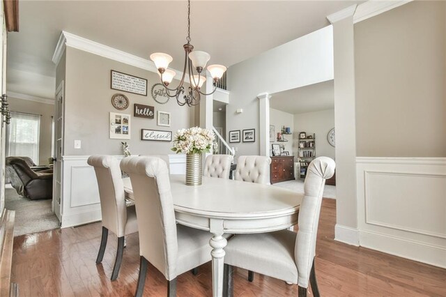 3060 Mccannon Mill Dr, Dacula, GA 30019 - dining space with a chandelier, ornamental molding, wainscoting, wood finished floors, and decorative columns