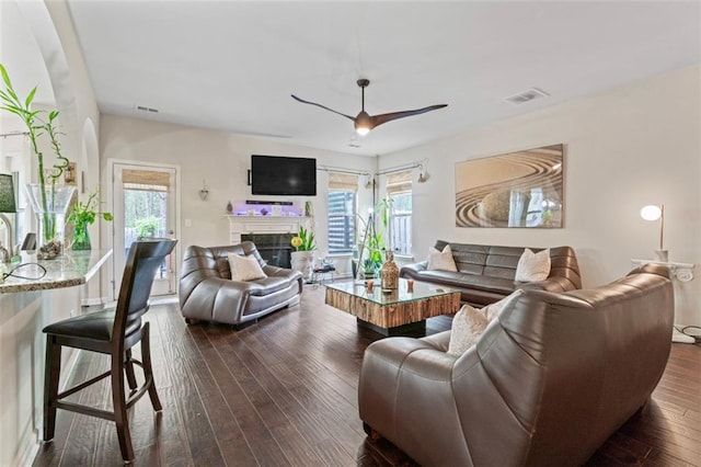 living room featuring dark hardwood / wood-style floors and ceiling fan