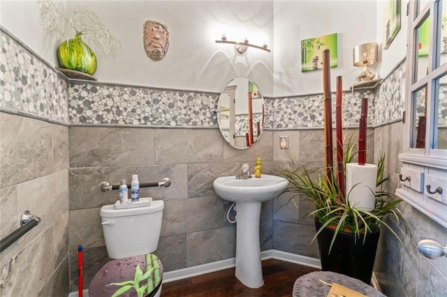 bathroom featuring tile walls, sink, wood-type flooring, and toilet