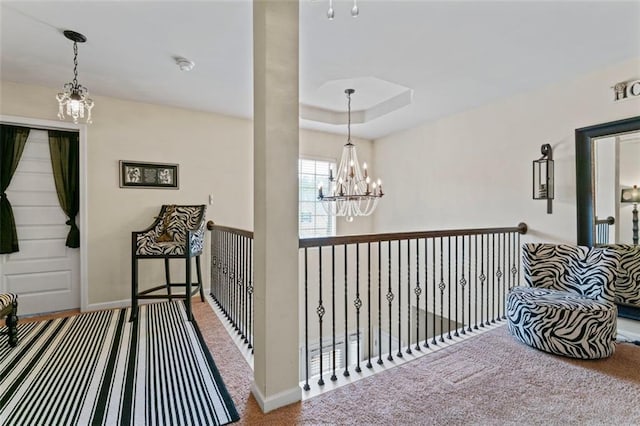 hall featuring carpet and an inviting chandelier