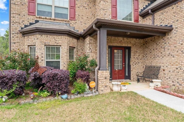 entrance to property with a lawn