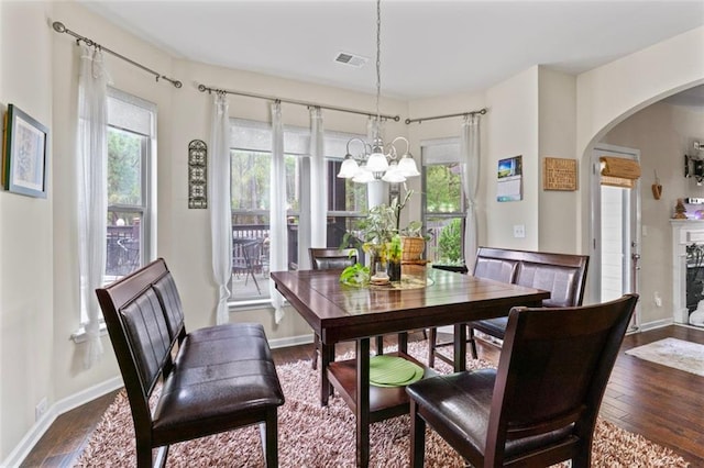 dining space featuring a notable chandelier and dark hardwood / wood-style floors