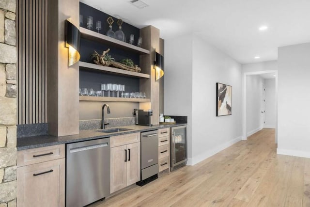 bar featuring wine cooler, sink, light brown cabinets, dishwasher, and light hardwood / wood-style floors