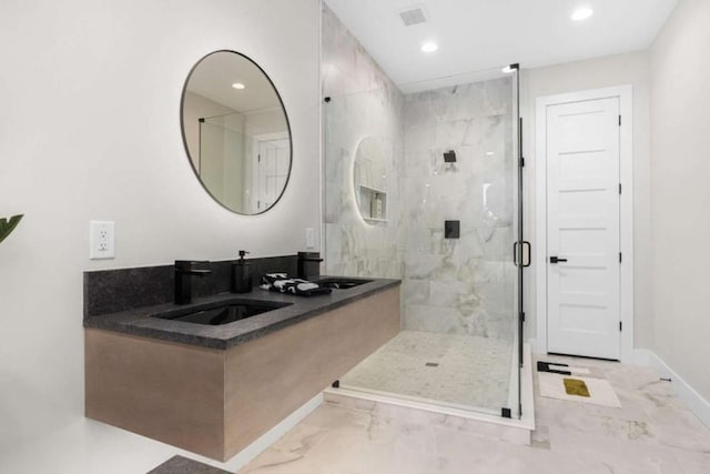 bathroom with vanity and a shower with shower door