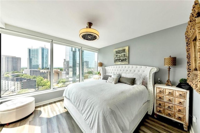 3338 Peachtree Rd NE Unit 1507, Atlanta, GA 30326 - bedroom with wood finished floors, a city view, and ceiling fan