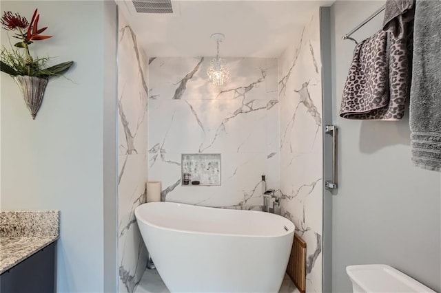 3338 Peachtree Rd NE Unit 1507, Atlanta, GA 30326 - bathroom featuring a freestanding tub, vanity, and marble finish floors