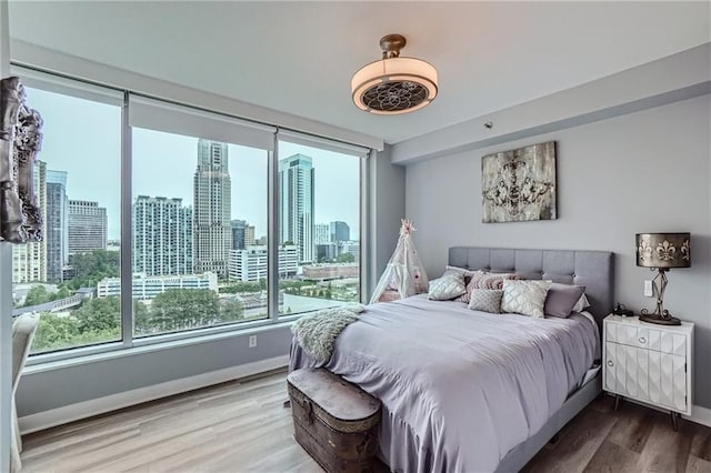 3338 Peachtree Rd NE Unit 1507, Atlanta, GA 30326 - bedroom with wood finished floors and a view of skyline