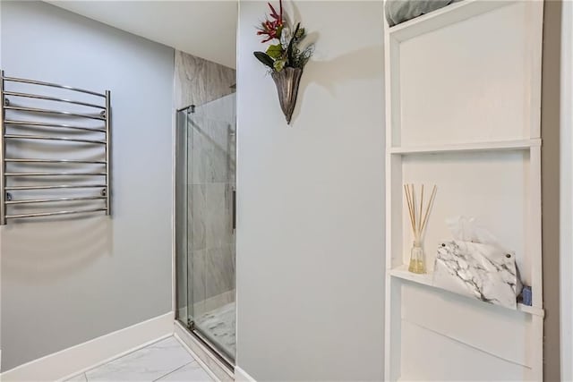 3338 Peachtree Rd NE Unit 1507, Atlanta, GA 30326 - full bathroom with radiator, marble finish flooring, a towel warmer, and a shower stall