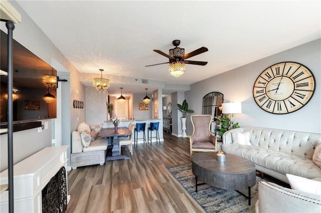 3338 Peachtree Rd NE Unit 1507, Atlanta, GA 30326 - living room featuring wood finished floors, ceiling fan, and a chandelier