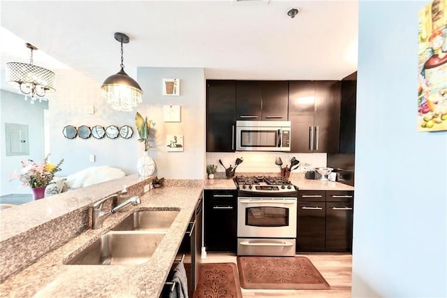 3338 Peachtree Rd NE Unit 1507, Atlanta, GA 30326 - kitchen featuring appliances with stainless steel finishes, light stone countertops, hanging light fixtures, light wood-type flooring, and electric panel